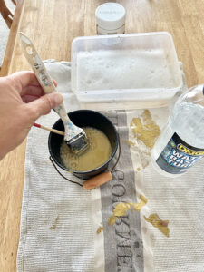 Diggers Water Based Turps on table cleaning paint brushes