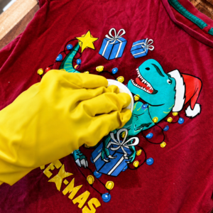 Gently dabbing damaged t-shirt graphic with acetone